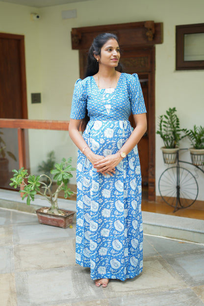 A full-length royal blue cotton maxi nighty with a dual floral print, square neck, and puff sleeves.
