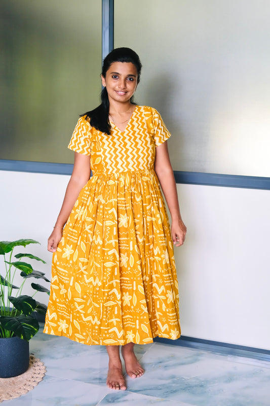 Mustard yellow cotton midi nighty with a chevron printed bodice and gathered skirt.