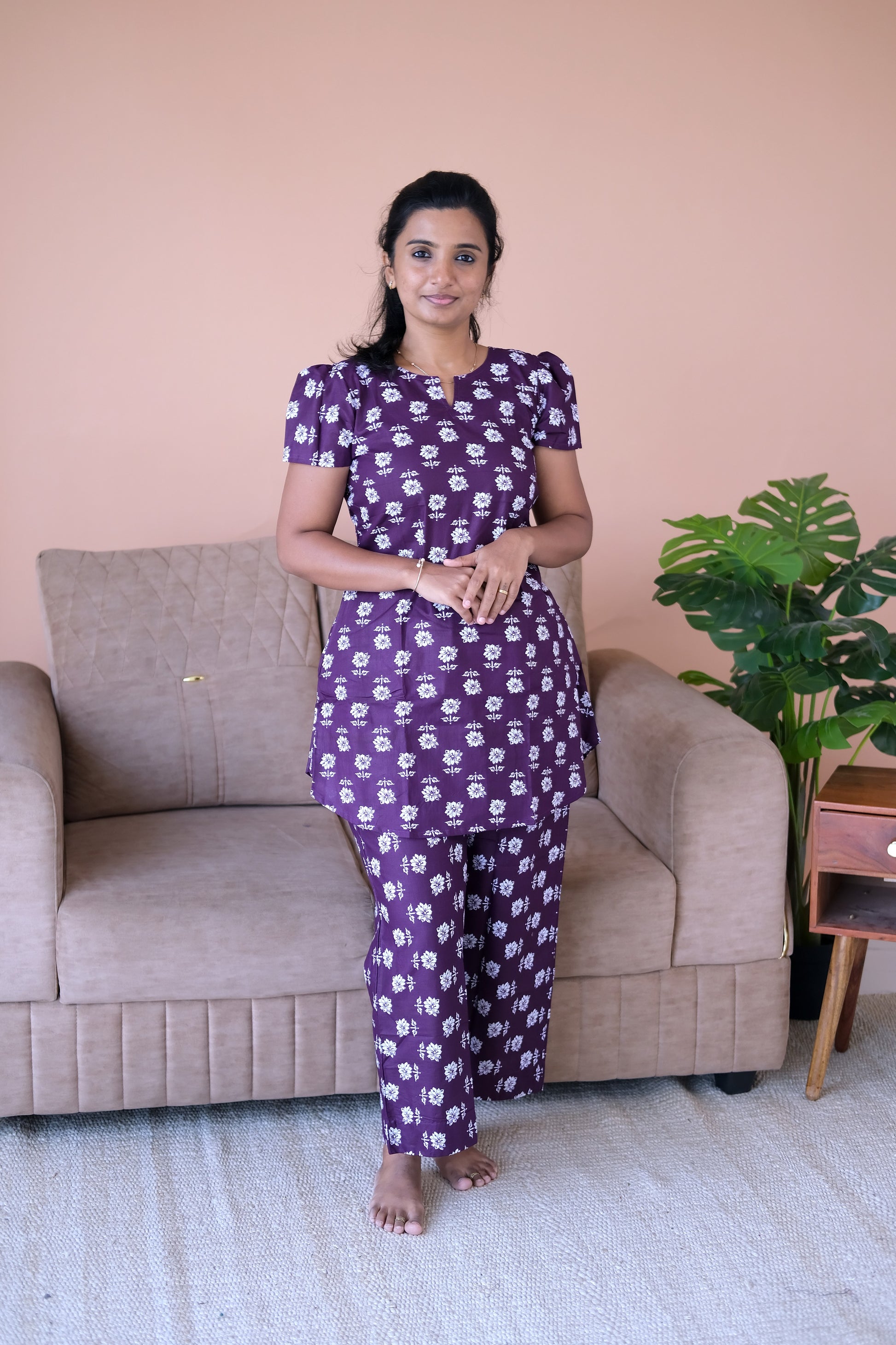 Plum cotton night suit for women featuring a floral printed top with puff sleeves and matching straight pants.