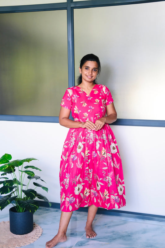 Bright pink floral cotton midi nighty with a gathered waist and V-neckline.