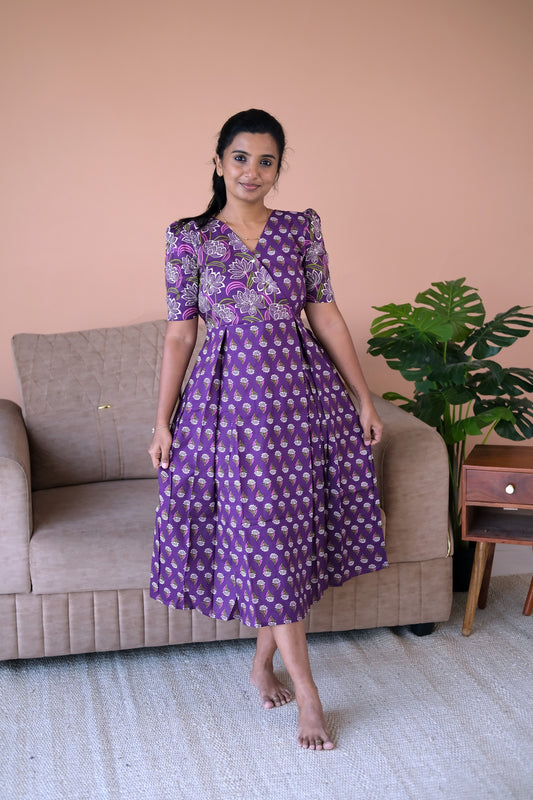 A violet cotton midi nighty with a floral print, crossover V-neckline, and pleated skirt.