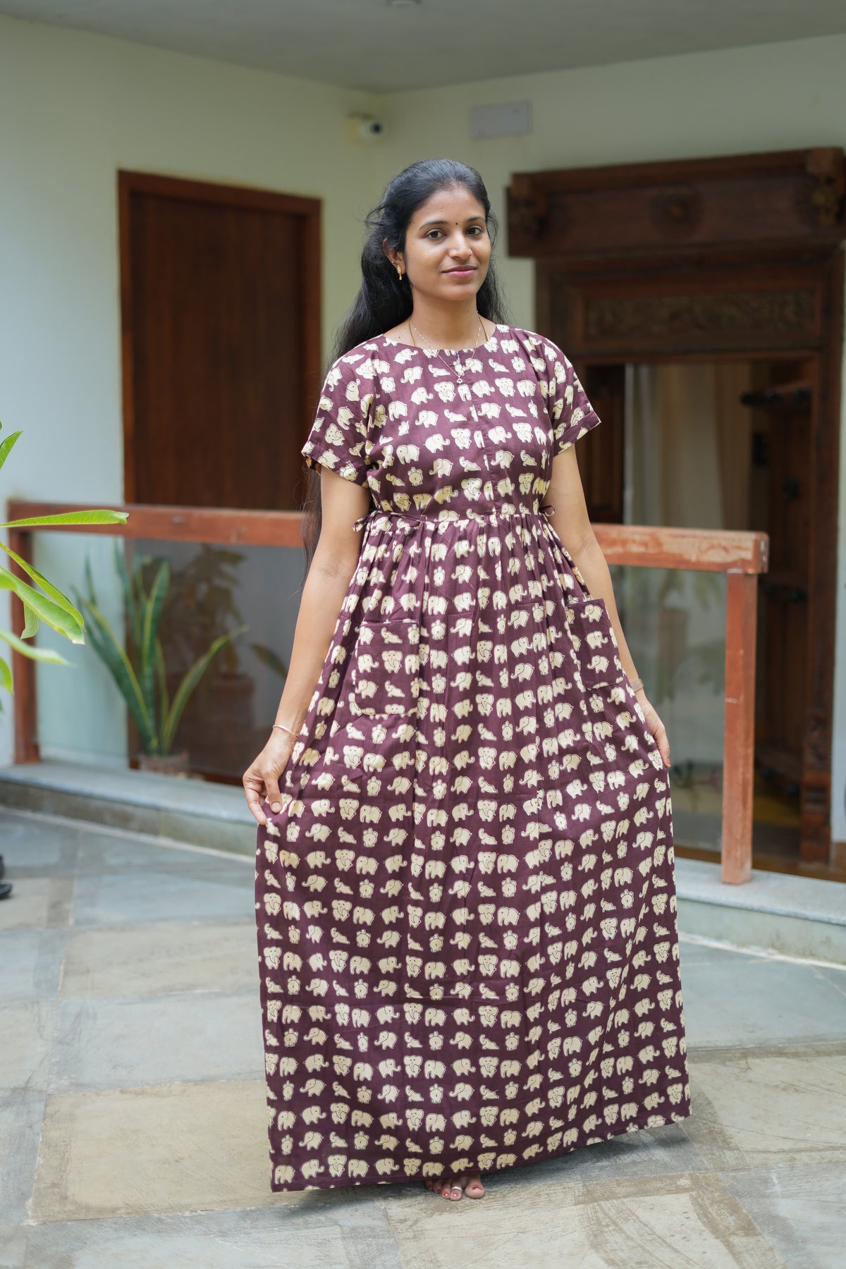 A printed cotton nighty in dusty plum showing the relaxed maxi fit and front patch pockets.