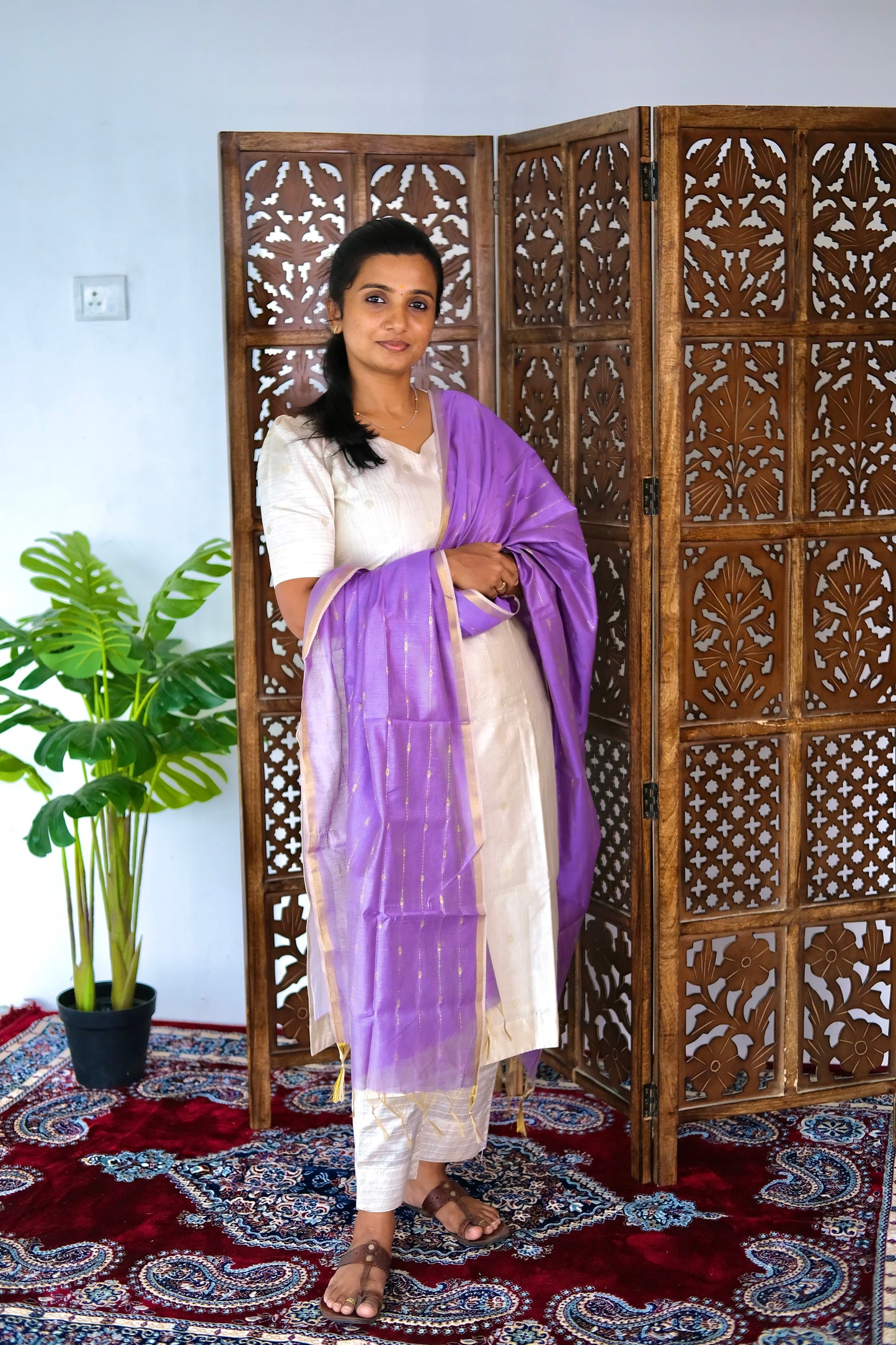 full-length view of the off white raw silk kurti set with a draped lavender dupatta showcasing gold zari borders