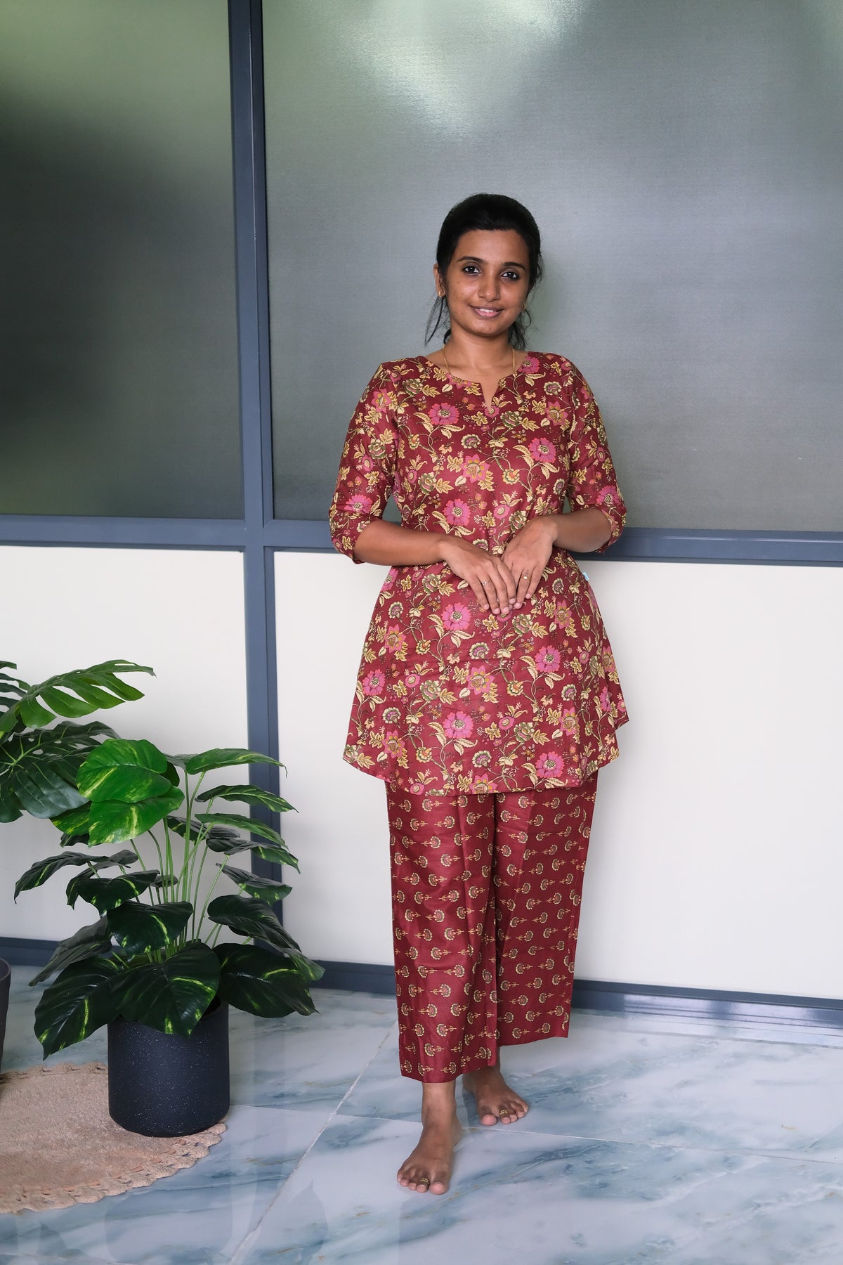 Wine red cotton night suit for women featuring a floral print kurti-style top and matching straight-fit pants.