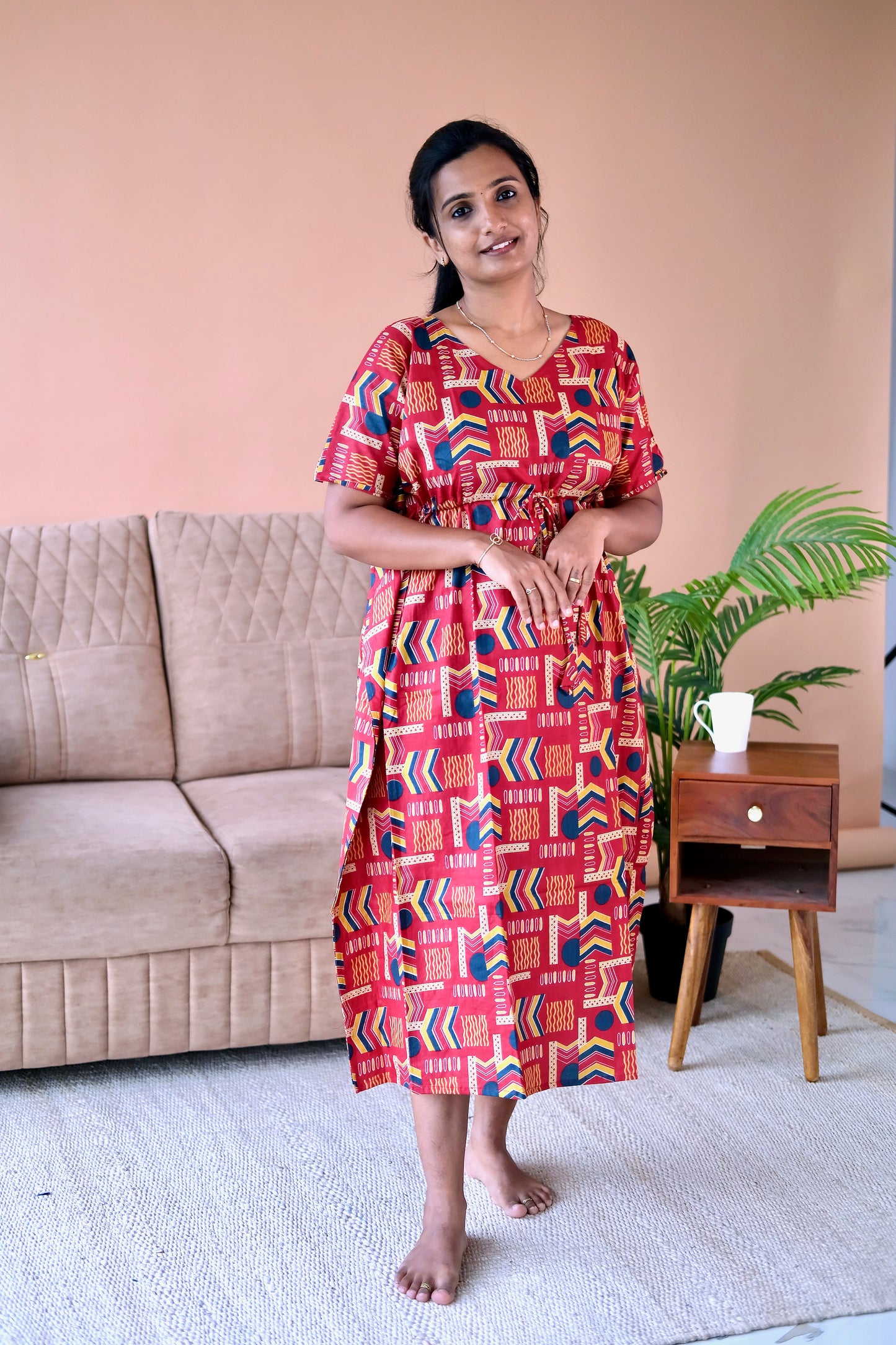 Side view of the red cotton loungewear dress showing the side slit and midi length