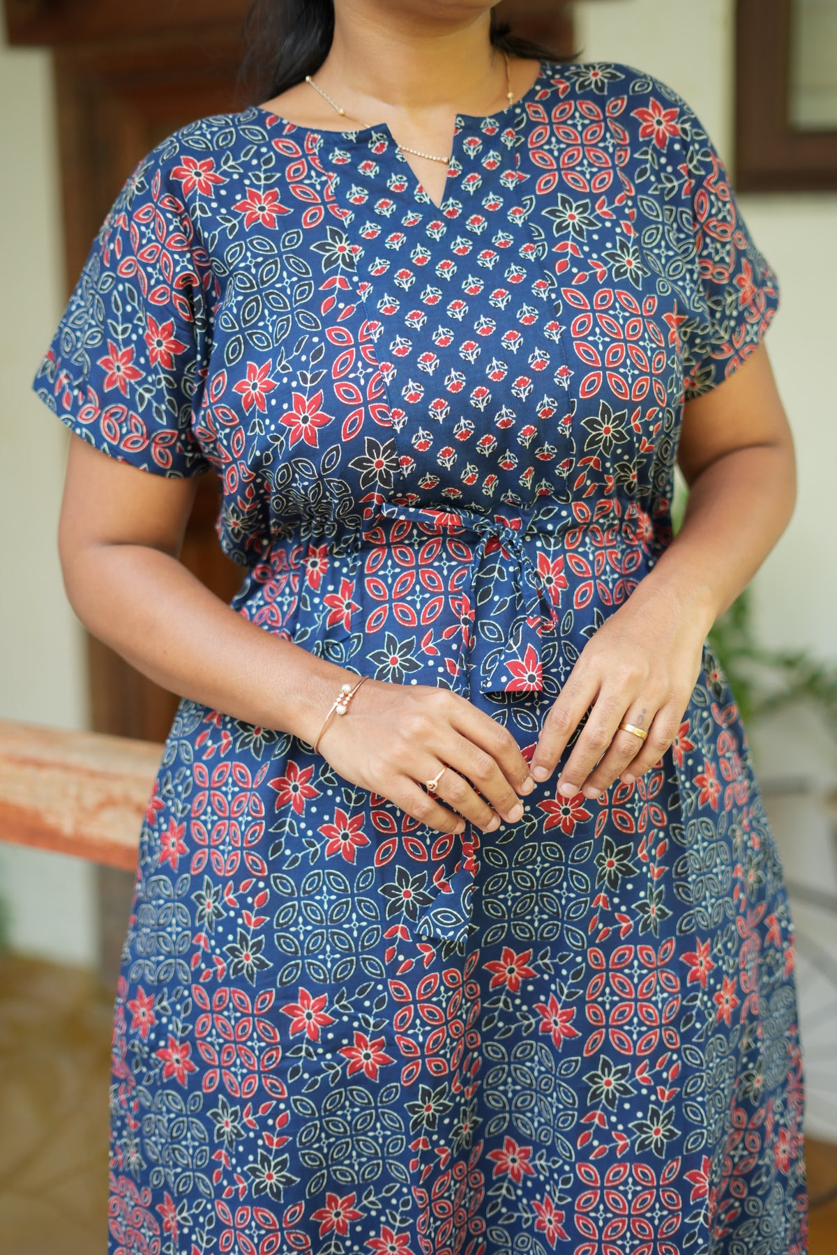 Close up of notched neck and tie-up detail on navy blue feeding nighty