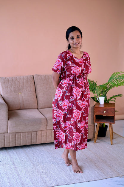 Midi-length cotton loungewear dress in maroon with a blooming pink floral pattern and a cinched drawstring waist.