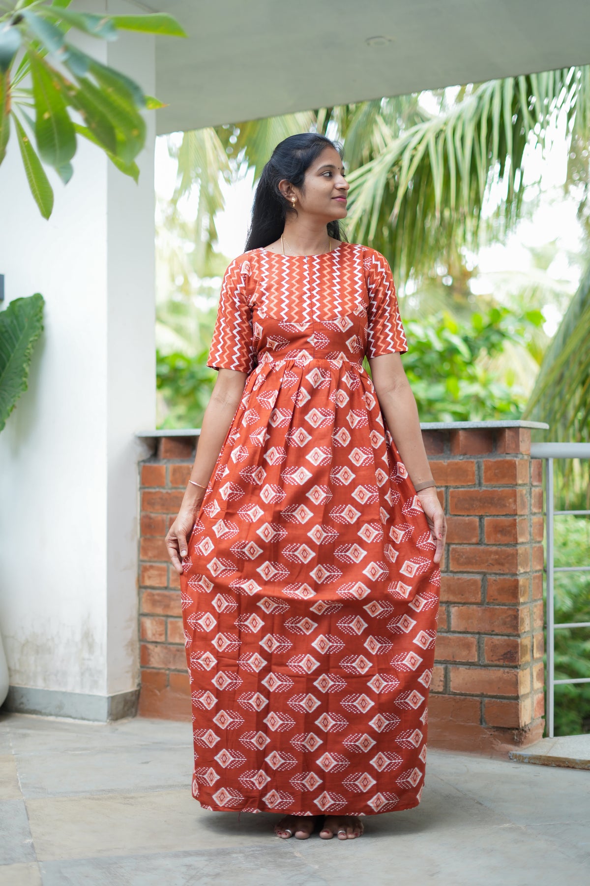 Full length view of a comfortable ladies cotton nighty in rust orange with a gathered waist