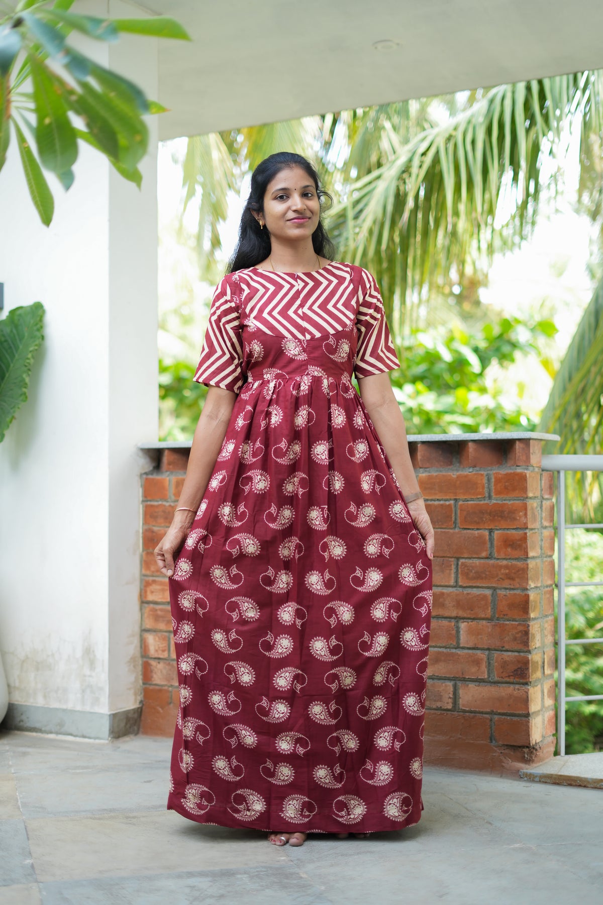 Full-length view of a comfortable maroon cotton maxi nighty with a relaxed fit.